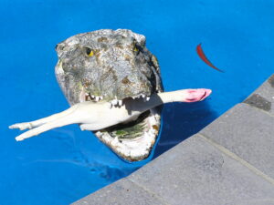 Crocodile with bird in its mouth