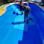 2 men Painting pool